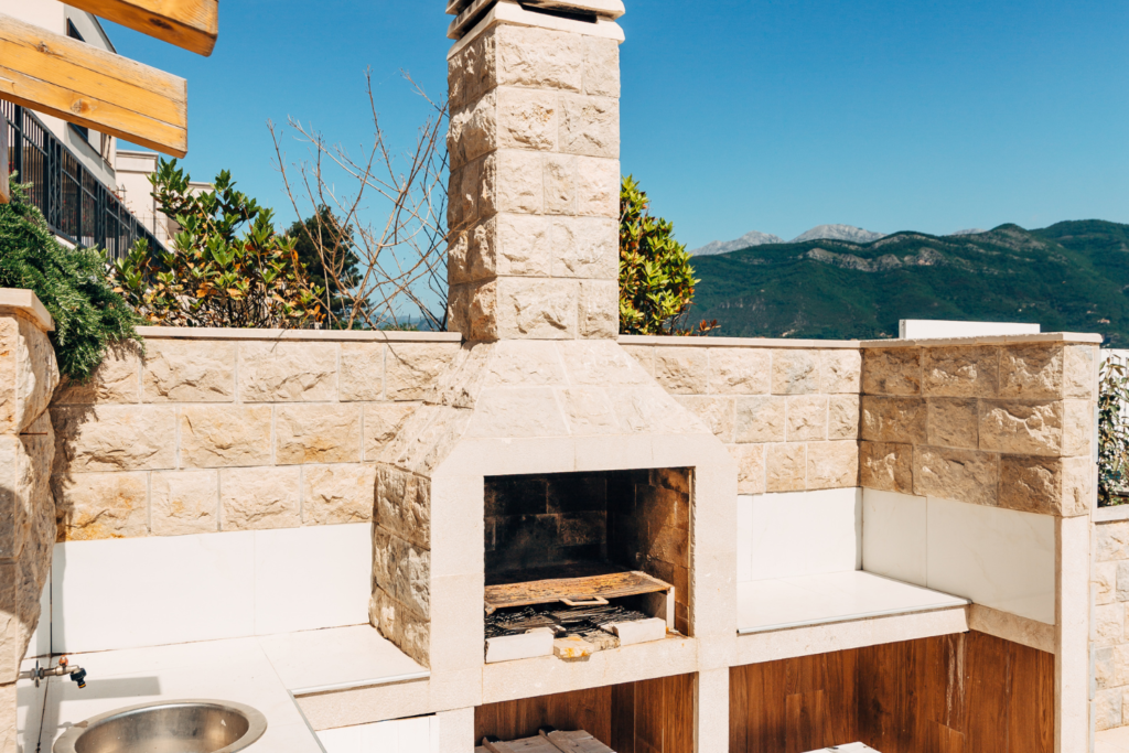 A stone oven built in with counter top on a patio