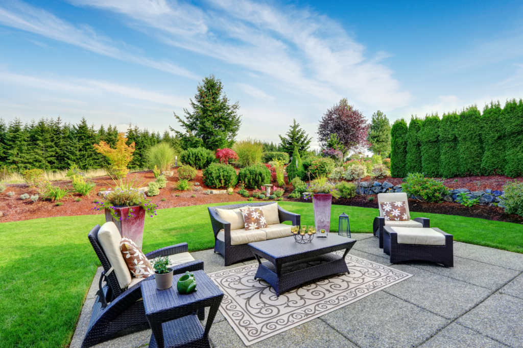 a stone patio with outdoor wicker furniture