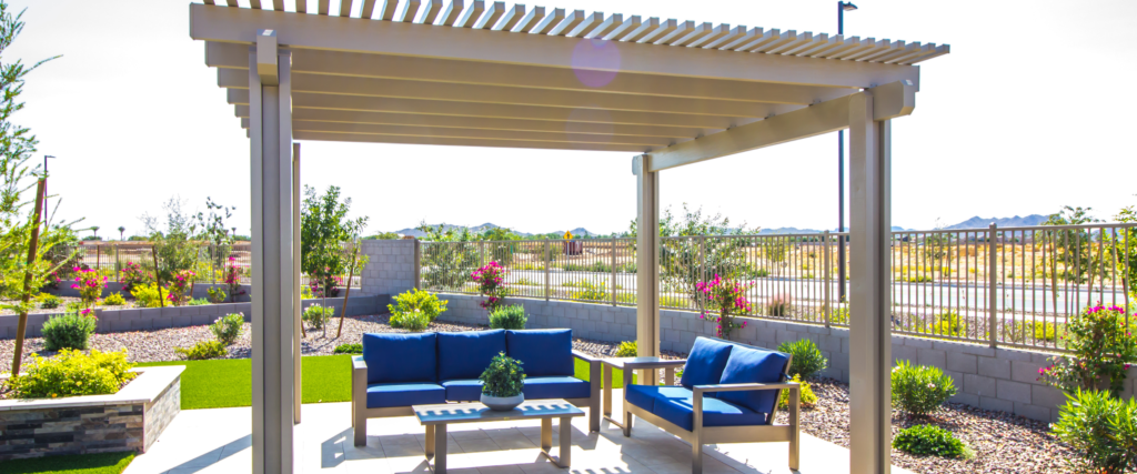 a wood pergola over a concrete patio with patio furniture.