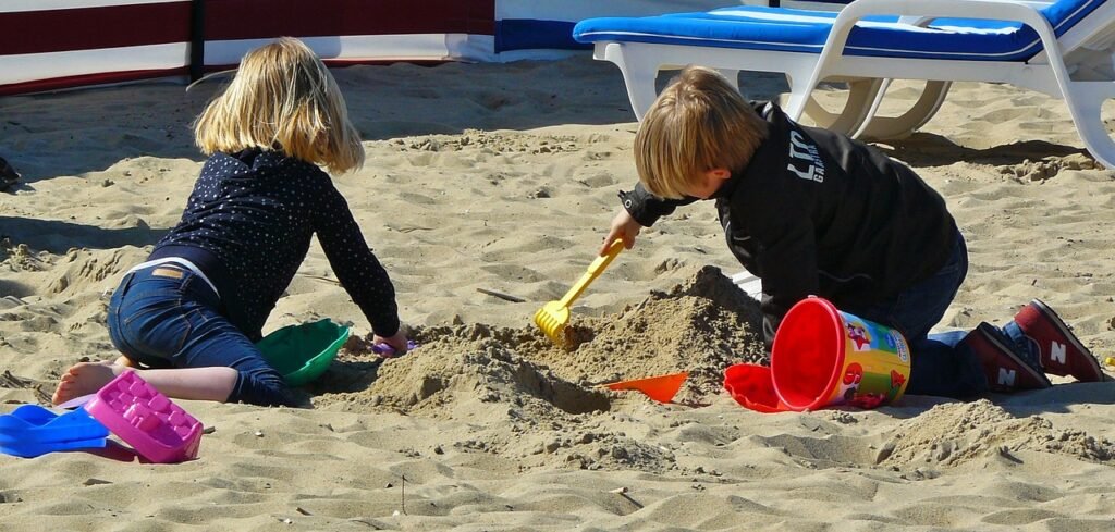 two children playing in a sandbox