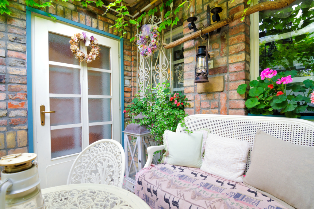 Apartment patio garden with plants hanging and flowers