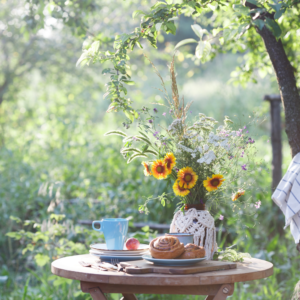 Fairy tea garden table with coffee cups and yellow flowers