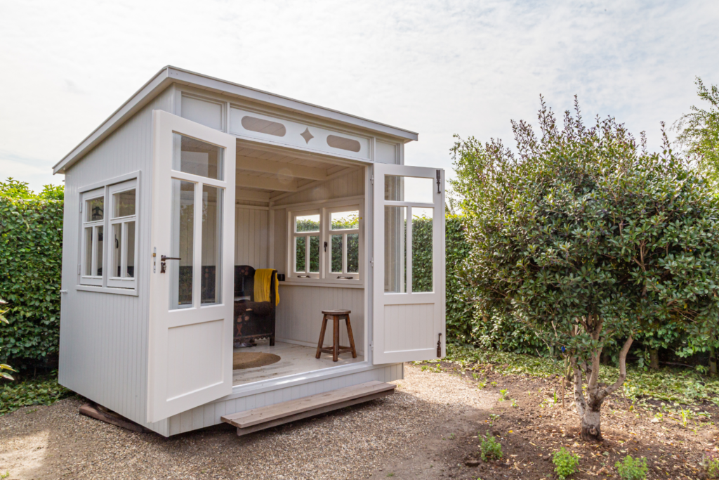 Shed with door open and couch inside