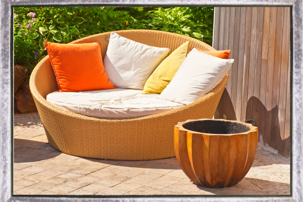 cozy patio egg chair orange and yellow pillows